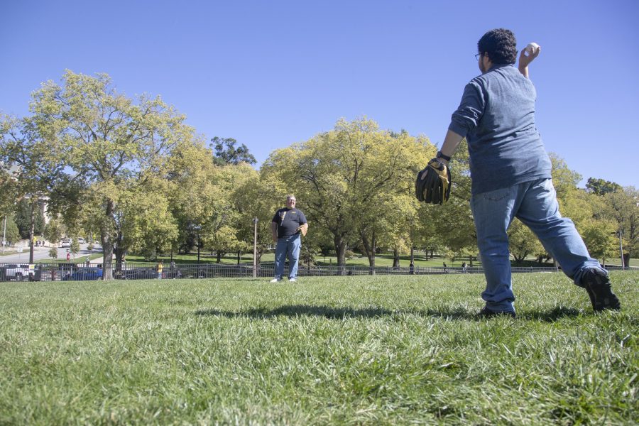 Daily Iowan reporter Alejandro Rojas throws the ball to Johnson County Supervisor Rod Sullivan during a game of catch in Hubbard Park on Wednesday, Sept. 28, 2022.