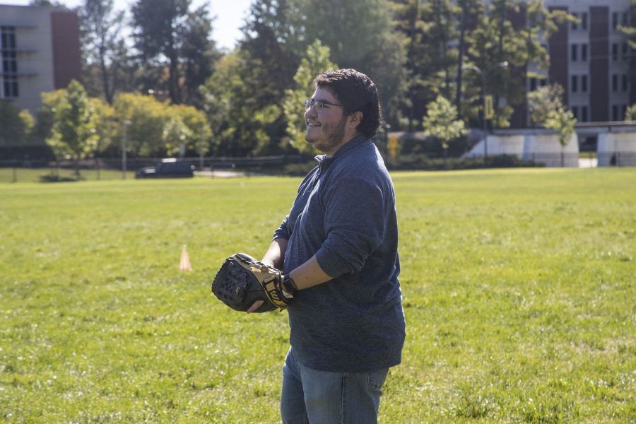 Daily Iowan reporter Alejandro Rojas smiles during a game of catch in Hubbard Park on Wednesday, Sept. 28, 2022.