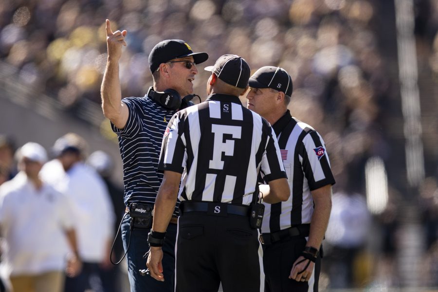 Michigan head coach Jim Harbaugh speaks with officials during a football game between Iowa and No. 4 Michigan at Kinnick Stadium in Iowa City on Saturday, Oct. 1, 2022.