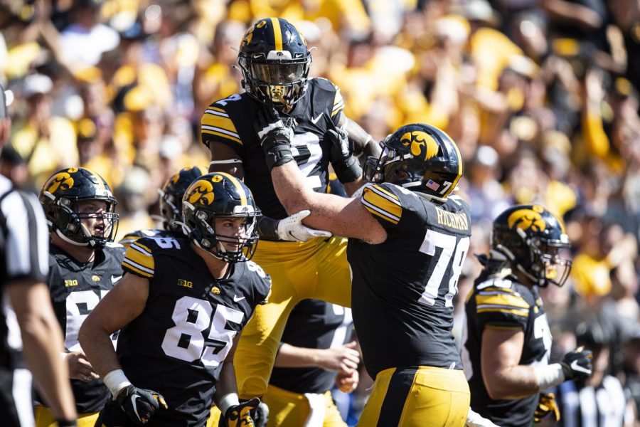 Iowa offensive lineman Mason Richman (78) hoists running back Kaleb Johnson (2) after Johnson scored a touchdown during a football game between Iowa and No. 4 Michigan at Kinnick Stadium in Iowa City on Saturday, Oct. 1, 2022. The Wolverines defeated the Hawkeyes, 27-14. 