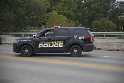 An Iowa City police car arrives after a semi-truck got stuck on the Iowa Avenue bridge on Wednesday, Oct. 5, 2022.