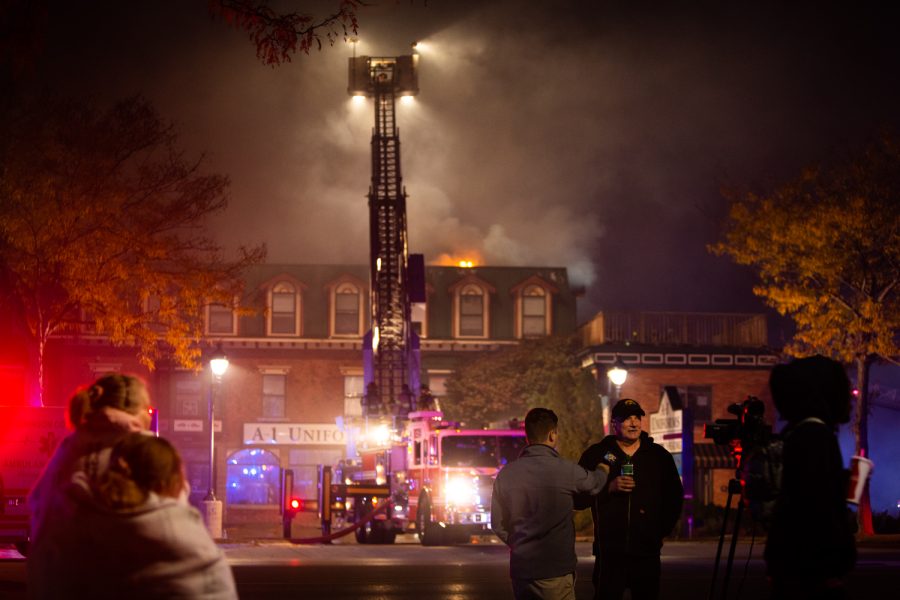 KCRG reporter Brian Tabick conducts an interview across the street from 304 2nd St. in Coralville, Iowa after a fire broke out on Saturday, Oct. 8, 2022. The fire started around 7:30 p.m.