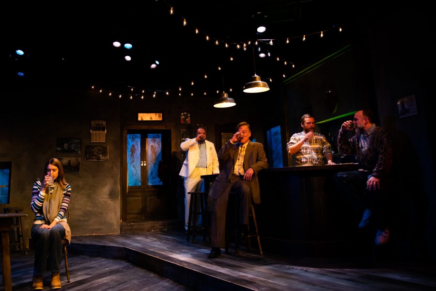 Cast members drink at a dress rehearsal for the play The Weir at Riverside Theatre in Iowa City on Wednesday, Oct. 12, 2022. The Weir depicts a story about a rural bar in Ireland.
