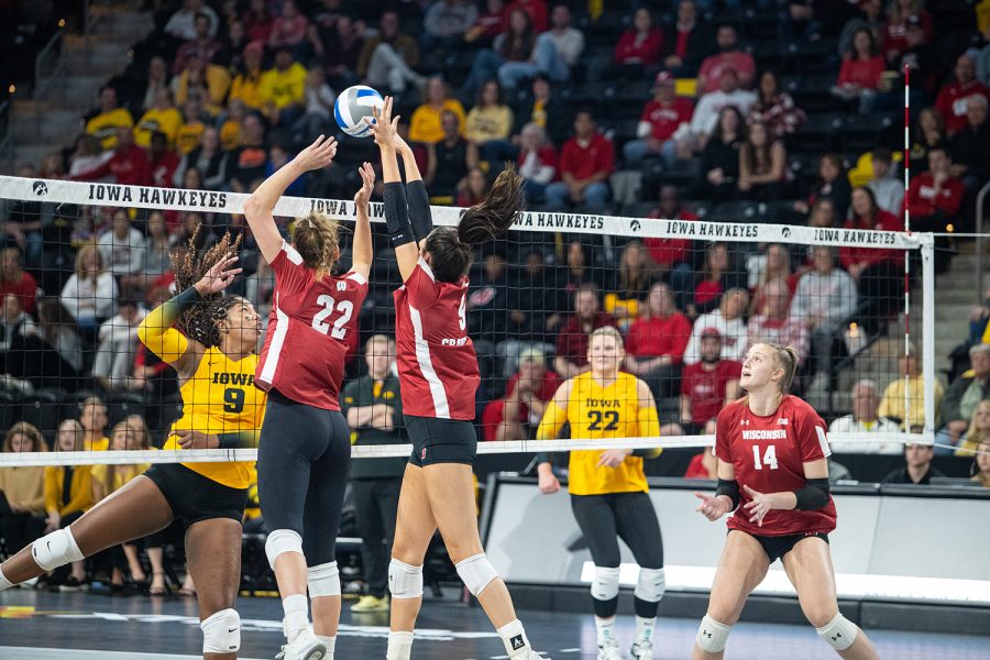 Wisconsin middle blocker Caroline Crawford sets the ball during a volleyball match between Iowa and Wisconsin at Xtream Arena in Coralville on Friday, October 14, 2022. The Badgers defeated the Hawkeyes, 25-19. 