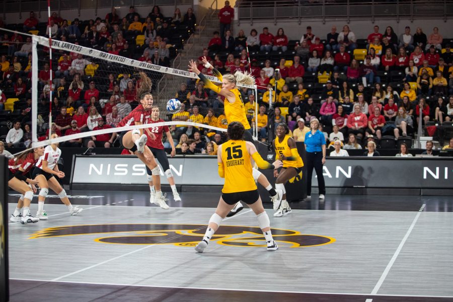 Iowa middle hitter Delaney McSweeney prepares to block the ball during a volleyball match between Iowa and Wisconsin at Xtream Arena in Coralville on Friday, Oct. 14, 2022. The Badgers defeated the Hawkeyes, 3-0.