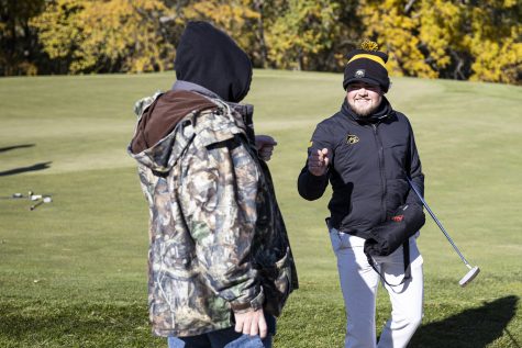 Iowa’s Mac McClear fist bumps a spectator during the Iowa Fall Classic at Blue Top Ridge Golf Course in Riverside, Iowa, on Monday, Oct. 17, 2022. McClear won the tournament after shooting two under par. The Hawkeyes defeated eight other teams to win the tournament, shooting 20 over par.