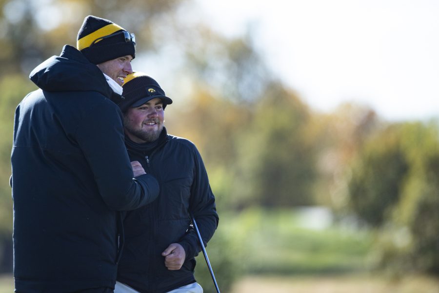 Iowa’s Mac McClear celebrates a tournament victory with assistant coach Charlie Hoyle during the Iowa Fall Classic at Blue Top Ridge Golf Course in Riverside, Iowa, on Monday, Oct. 17, 2022. The Hawkeyes defeated eight other teams to win the tournament, shooting 20 over par.