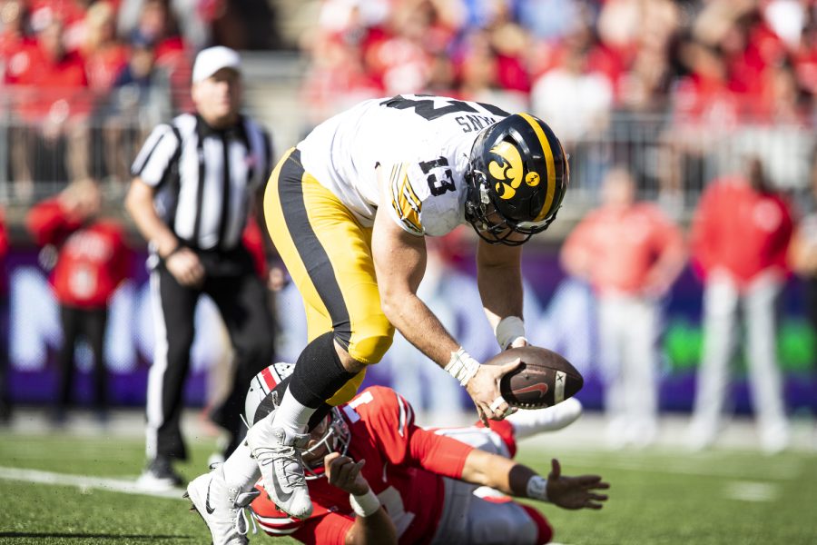 Iowa defensive lineman Joe Evans scoops a fumble up during a football game between Iowa and No. 2 Ohio State at Ohio Stadium in Columbus, Ohio, on Saturday, Oct. 22, 2022. 
