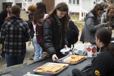 A block party-goer grabs a plate of egg rolls at the Homecoming Multicultural Block Party on Tuesday, October 25, 2022.