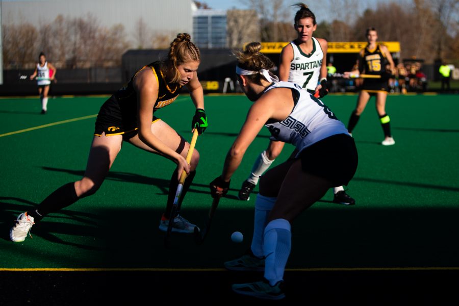 Iowa midfielder Lokke Stribos fights for the ball during a field hockey game between Iowa and Michigan State at Grant Field in Iowa City on Friday, Oct. 28, 2022. The Hawkeyes defeated the Spartans, 1-0.