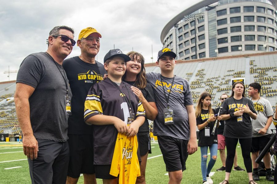 Kid captain Cormac Faley poses for a photo with his guests and head coach Kirk Ferentz during Iowa football’s Kids’ Day at Kinnick in Iowa City on Saturday, Aug. 13, 2022. 