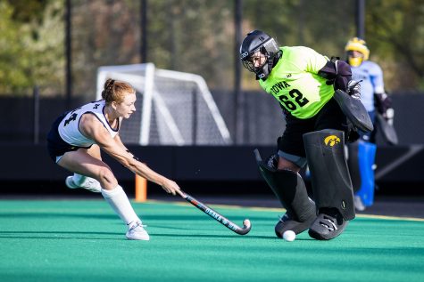 Michigan forward Katie Anderson takes a shot at the goal as Iowa goalkeeper Grace McGuire moves to block during a field hockey game between No.1 Iowa and No. 2 Michigan on Friday, Oct. 15, 2021, at Grant Field. The Hawkeyes defeated the Wolverines 2-1 in double overtime and a shootout.