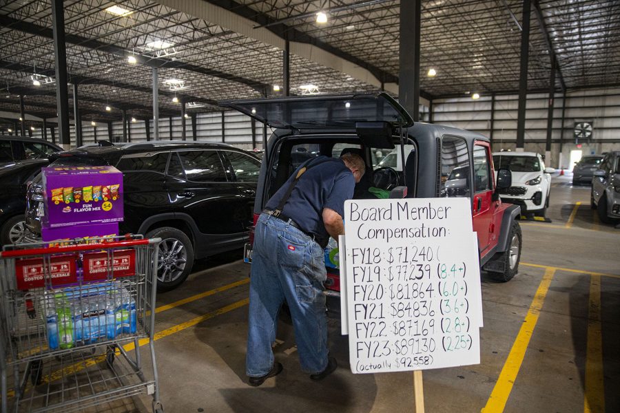 As Phil loads groceries for a campaign event in the back of his stick-shift jeep, a sign displaying the increase of Supervisors salary is within arms reach. Phil sees the steady increase in salary as a problem to be fixed and said, “As a taxpayer and as a candidate I think we can do better.” (Ayrton Breckenridge/The Daily Iowan)