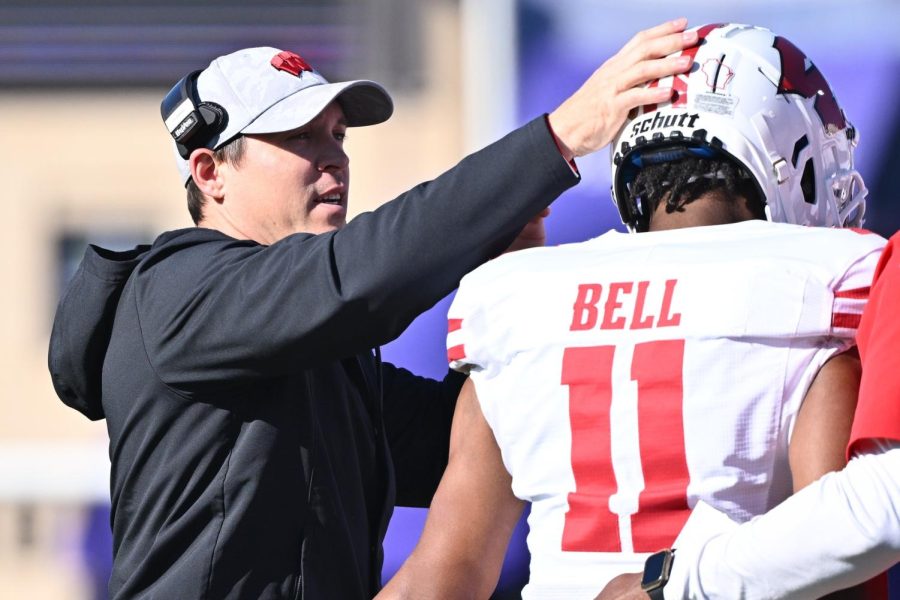 Oct 8, 2022; Evanston, Illinois, USA; Wisconsin Badgers interim head coach Jim Leonhard congratulates wide receiver Skyler Bell (11) after Bell caught a touchdown pass in the first quarter against the Northwestern Wildcats at Ryan Field. 