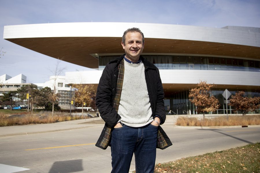 Aaron Greenwald, the new programming and engagement director of Hancher Auditorium, poses for a photo outside of Hancher on Thursday, Oct. 27, 2022.