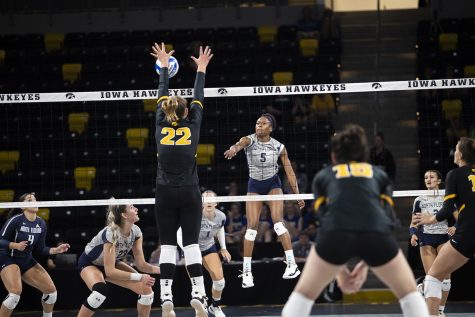 North Florida outside hitter Mahalia White spikes the ball while Iowa outside hitter Addie VanderWeide blocks the ball  during a volleyball match between Iowa and North Florida at Xtream Arena in Coralville on Friday, Sept. 16, 2022. The Hawkeyes defeated the Ospreys 3-0. 