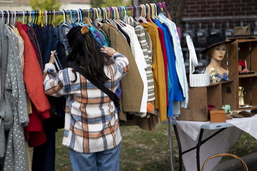 An attendee rummages through clothes at a flea market at Public Space One Close House Oct.16, 2022. 