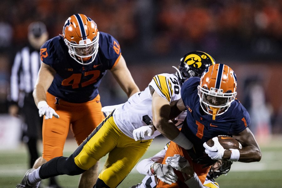 Iowa defensive back Quinn Schulte tackles Illinois wide receiver Isaiah Williams during a football game between Iowa and Illinois at Memorial Stadium in Champaign, Ill., on Saturday, Oct. 8, 2022.