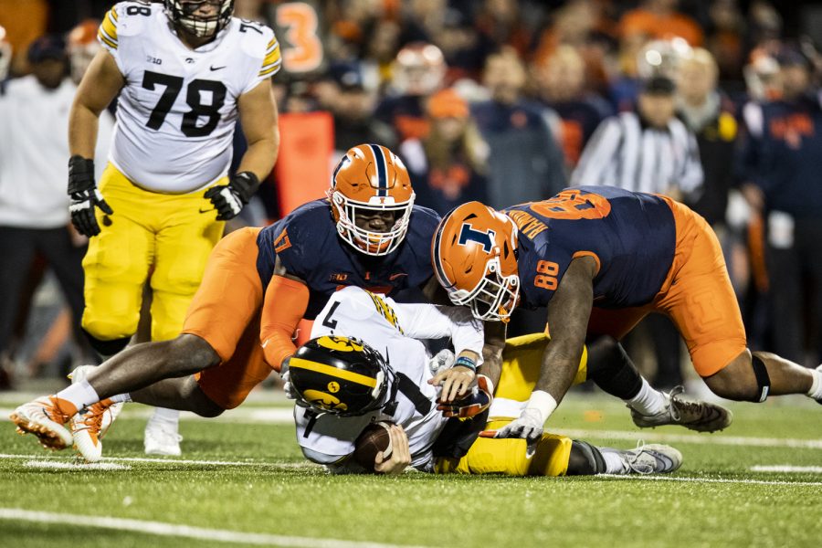 Illinois defensive lineman Keith Randolph Jr. sacks Iowa quarterback Spencer Petras during a football game between Iowa and Illinois at Memorial Stadium in Champaign, Ill., on Saturday, Oct. 8, 2022.