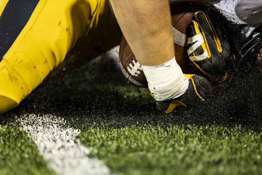 Iowa linebacker Seth Benson recovers a fumble during a football game between Iowa and Illinois at Memorial Stadium in Champaign, Ill., on Saturday, Oct. 8, 2022.