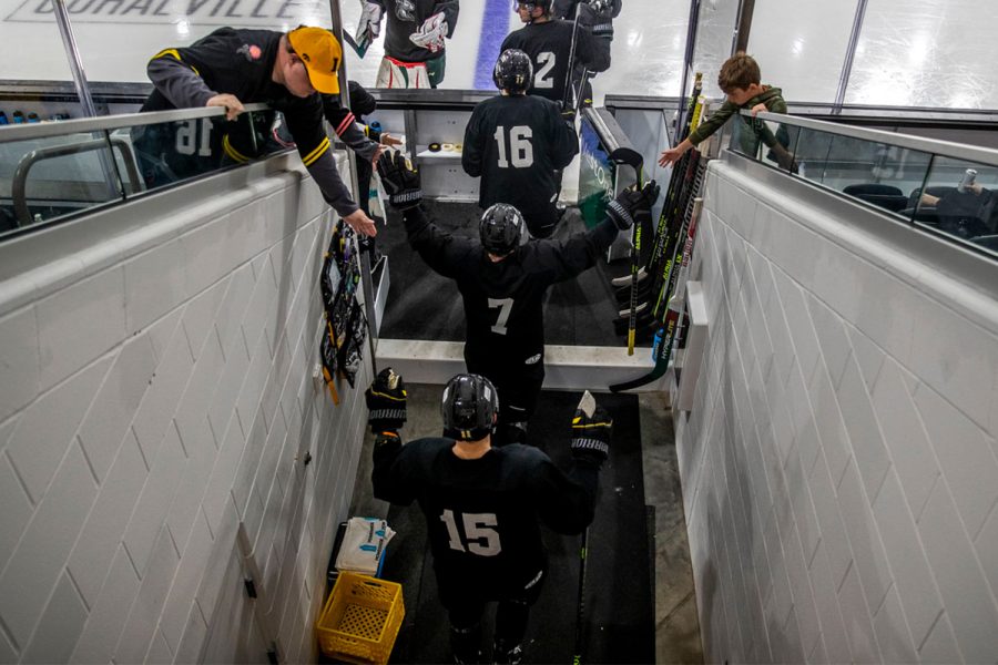 Guss van Nes and his teammates enter the arena during a Heartlanders scrimmage at Xtream Arena in Coralville on Wednesday, Oct. 12, 2022. The Rose Team defeated the Dash Team 4-3.
