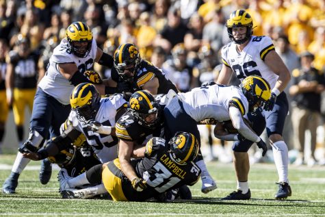 Michigan running Blake Corum fights for yards while running the ball during a football game between Iowa and No. 4 Michigan at Kinnick Stadium in Iowa City on Saturday, Oct. 1, 2022. Corum rushed for 133 yards. The Wolverines defeated the Hawkeyes, 27-14.