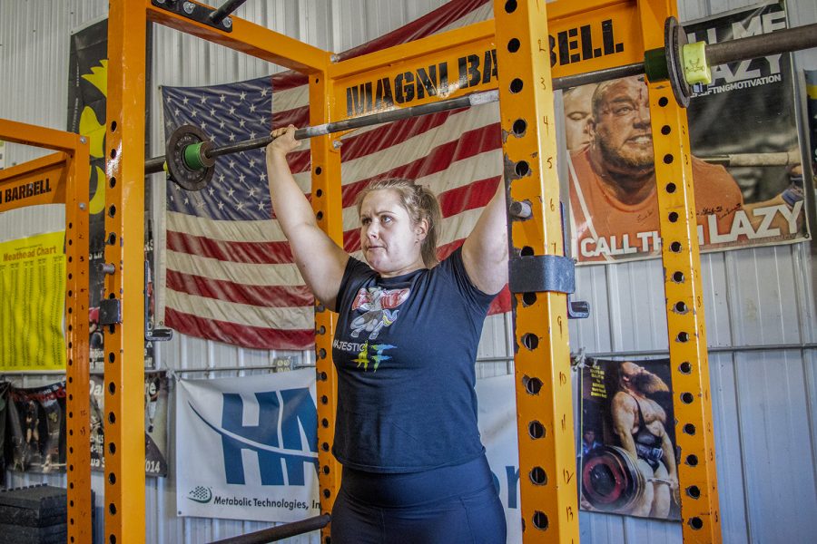 Jessica Gorzelitz overhead presses weights at Magni Gym in Coralville, Iowa, on Saturday, Oct. 15, 2022.