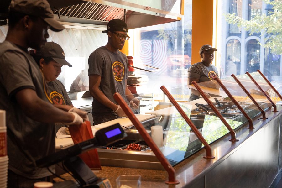 Employees work at the downtown Iowa City Pancheros Tuesday, October 17, 2022.