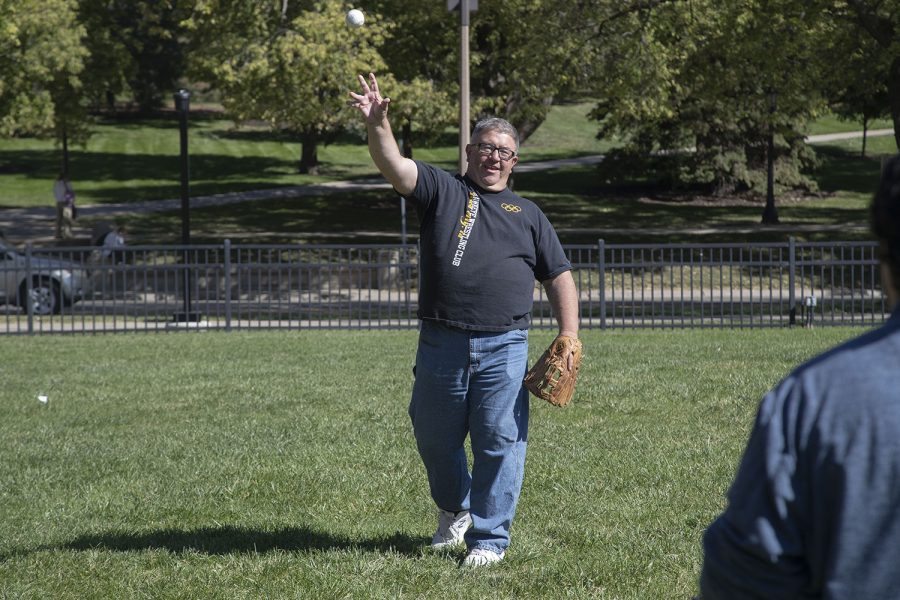 Johnson County Supervisor Rod Sullivan throws the ball to Daily Iowan reporter Alejandro Rojas during a game of catch in Hubbard Park on Sept. 28, 2022