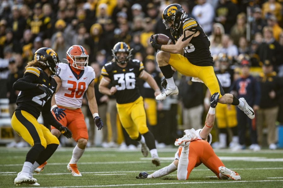 Iowa wide receiver Charlie Jones hurdles over Illinois defensive back Christian Bobak during a football game between No. 17 Iowa and Illinois at Kinnick Stadium in Iowa City on Saturday, Nov. 20, 2021. The Hawkeyes defeated the Illini 33-23 at the last home game of the season. 