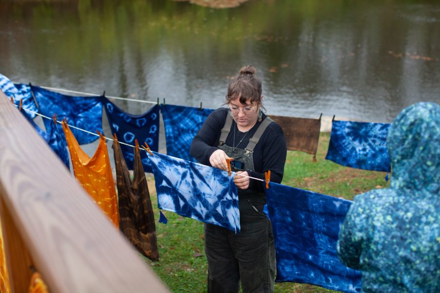 Event leader Ellen Wrede pins up a towel to dry at the Earth Friendly Tie-Dye event hosted by Backyard Abundance in Iowa City, Saturday, Nov. 5, 2022. 