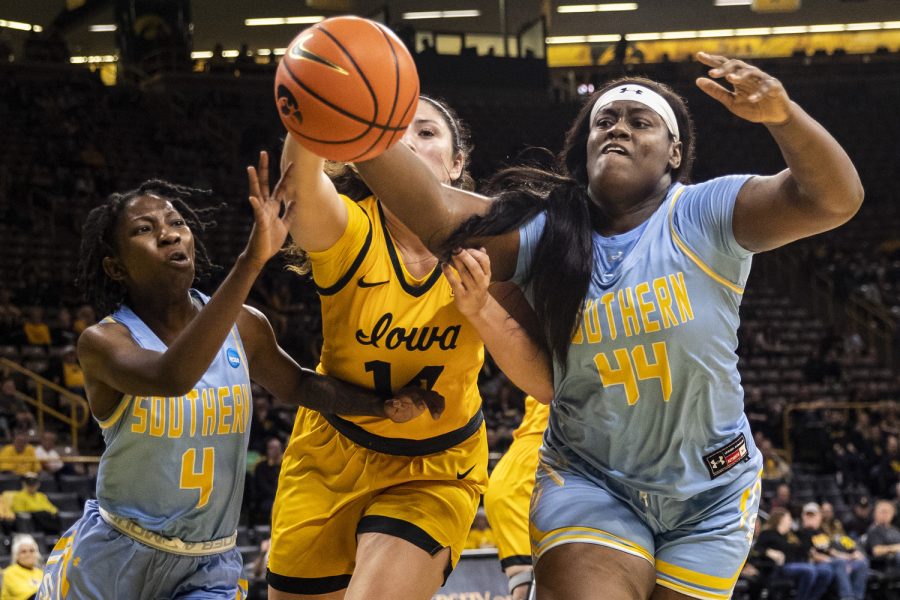 Southern University guard Chloe Fleming, center Raven White, and Iowa forward McKenna Warnock fight for a rebound during a women’s basketball game between Iowa and Southern University at Carver-Hawkeye Arena in Iowa City on Monday, Nov. 7, 2022. Iowa had 51 total rebounds. The Hawkeyes defeated the Jaguars, 87-34. 
