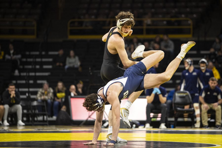 Iowa’s Cobe Siebrecht takes down Cal Baptist’s Joseph Mora during a wrestling meet between Iowa and Cal Baptist at Carver-Hawkeye Arena on Sunday, Nov. 13, 2022. Siebrecht defeated Mora in a 157-pound match by fall in four minutes and 59 seconds. The Hawkeyes defeated the Lancers, 42-3. 