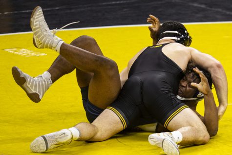 Iowa’s Tony Cassioppi holds down Cal Baptist’s Chris Island during a wrestling meet between Iowa and Cal Baptist at Carver-Hawkeye Arena on Sunday, Nov. 13, 2022. Cassioppi defeated Island in a 285-pound match by fall in two minutes and 13 seconds. The Hawkeyes defeated the Lancers, 42-3. 