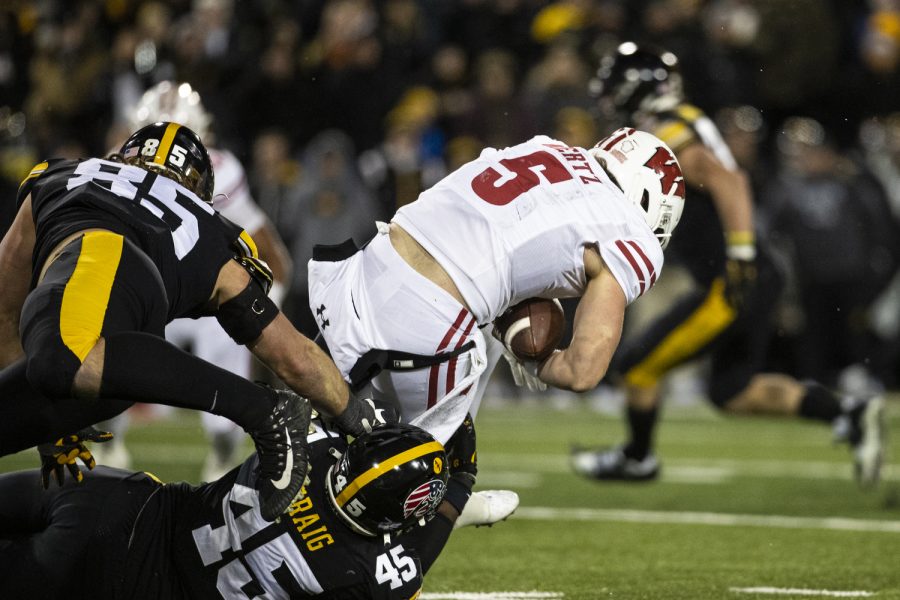 Iowa+defensive+lineman+Deontae+Craig+and+defensive+lineman+Logan+Lee+tackle+Wisconsin+quarterback+Graham+Mertz+during+a+football+game+between+Iowa+and+Wisconsin+at+Kinnick+Stadium+on+Saturday%2C+Nov.+12%2C+2022.+The+Iowa+defense+sacked+Mertz+four+times+and+forced+a+fumble.+The+Hawkeyes+defeated+the+Badgers%2C+24-10.
