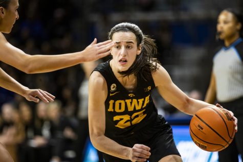 Iowa guard Caitlin Clark dribbles the ball during a basketball game between Iowa and Drake at the Knapp Center in Des Moines, Iowa, on Sunday, Nov. 13, 2022. Clark played for 42 minutes and 58 seconds. The Hawkeyes defeated the Bulldogs in overtime, 92-86.