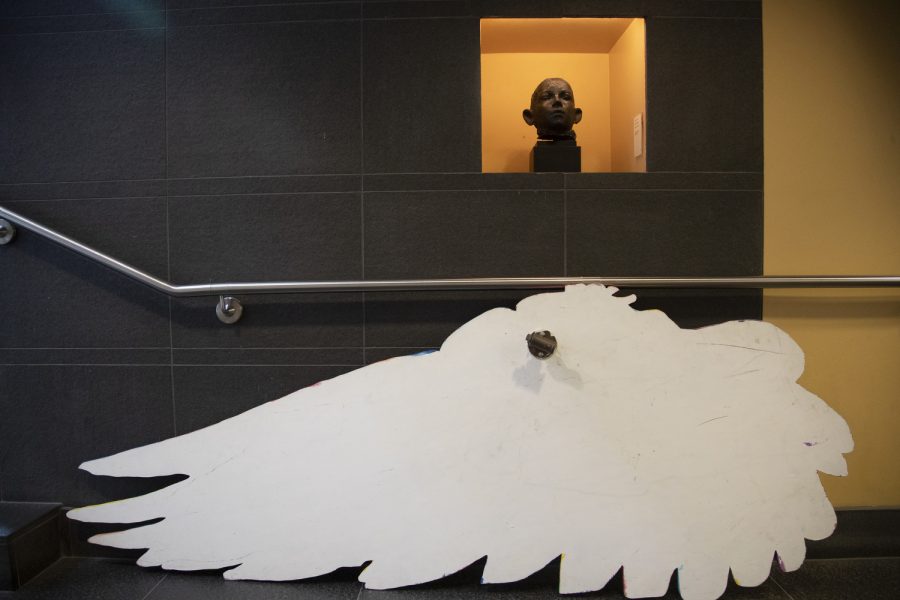 A wing of the No Foot Too Small art sculpture leans against a wall at the Iowa City Public Library Nov. 18, 2022. The wings raise awareness for pregnancy and infant loss; each feather being someone lost.