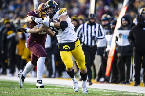 Iowa tight end Sam LaPorta runs after a reception during a football game between Iowa and Minnesota at Huntington Bank Stadium in Minneapolis on Saturday, Nov. 19, 2022. LaPorta caught four passes for 95 yards, but did not finish the game because of injury. The Hawkeyes defeated the Gophers, 13-10.