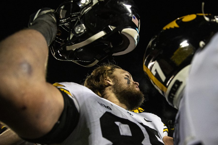 Iowa defensive lineman Logan Lee lifts his helmet while interacting with Iowa fans during a football game between Iowa and Minnesota at Huntington Bank Stadium in Minneapolis on Saturday, Nov. 19, 2022. Lee recorded five tackles in the game. The Hawkeyes defeated the Gophers, 13-10.
