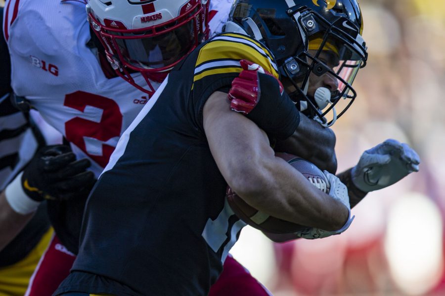 Iowa wide receiver Arland Bruce IV carries the ball during a football game between Iowa and Nebraska at Kinnick Stadium on Friday, Nov. 25, 2022. The Huskers lead the Hawkeyes at halftime, 17-0. (Ayrton Breckenridge/The Daily Iowan)