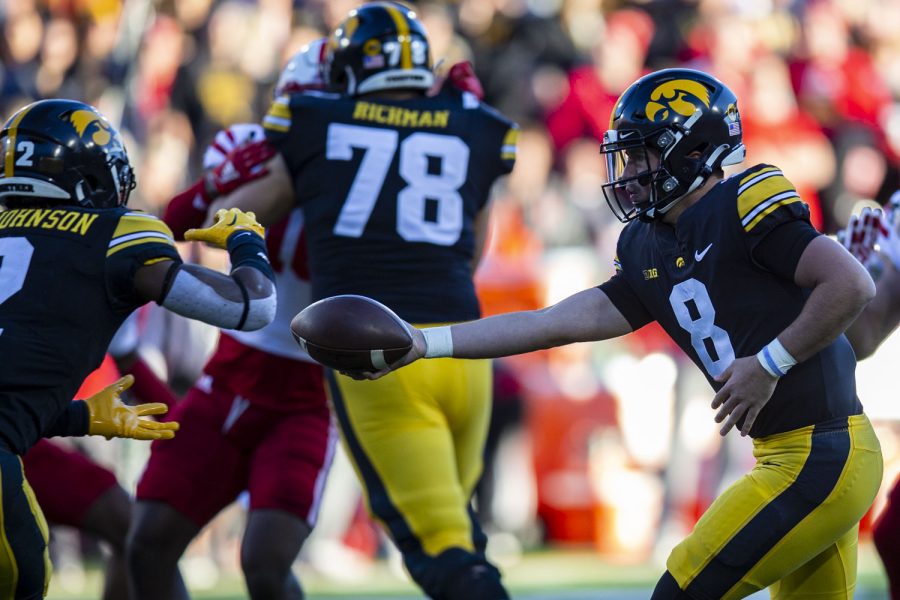 Iowa quarterback Alex Padilla hands the ball off during a football game between Iowa and Nebraska at Kinnick Stadium on Friday, Nov. 25, 2022. The Huskers lead the Hawkeyes at halftime, 17-0. (Ayrton Breckenridge/The Daily Iowan)