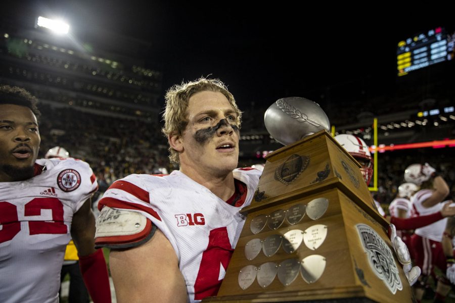 Nebraska defensive end Garrett Nelson carries the Heroes trophy after a football game between Iowa and Nebraska at Kinnick Stadium on Friday, Nov. 25, 2022. The Huskers defeated the Hawkeyes, 24-17.