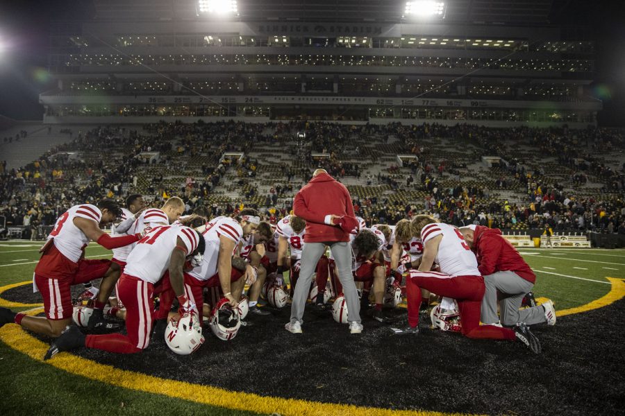 Nebraska players and coaches huddle up for a prayer after a football game between Iowa and Nebraska at Kinnick Stadium on Friday, Nov. 25, 2022. The Huskers defeated the Hawkeyes, 24-17.