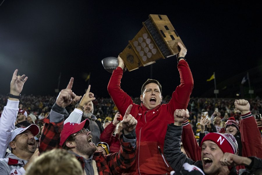 A Nebraska fan lifts the Heroes Trophy after a football game between Iowa and Nebraska at Kinnick Stadium on Friday, Nov. 25, 2022. The Huskers defeated the Hawkeyes, 24-17.