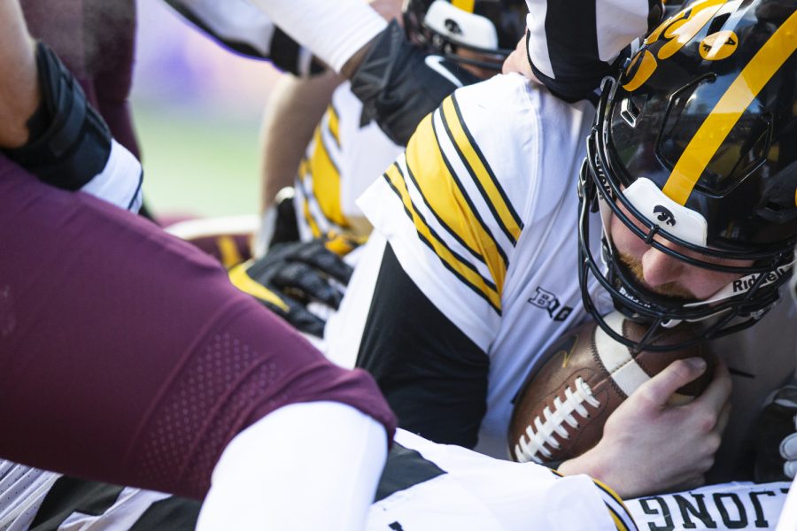 Iowa quarterback Spencer Petras rests after sneaking the ball in for a touchdown during a football game between Iowa and Minnesota at Huntington Bank Stadium in Minneapolis on Saturday, Nov. 19, 2022. (Jerod Ringwald/The Daily Iowan)