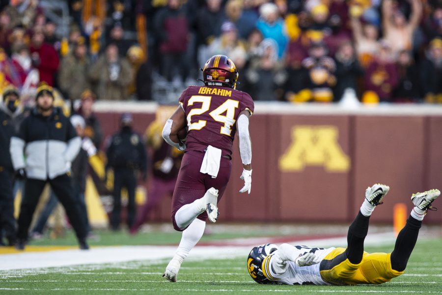 Minnesota running back Mohamed Ibrahim runs after breaking a tackle from Iowa defensive back Riley Moss during a football game between Iowa and Minnesota at Huntington Bank Stadium in Minneapolis on Saturday, Nov. 19, 2022. (Jerod Ringwald/The Daily Iowan)