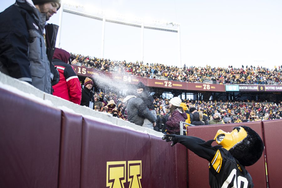 Herky throws a snowball at a Minnesota fan during a football game between Iowa and Minnesota at Huntington Bank Stadium in Minneapolis on Saturday, Nov. 19, 2022. (Jerod Ringwald/The Daily Iowan)