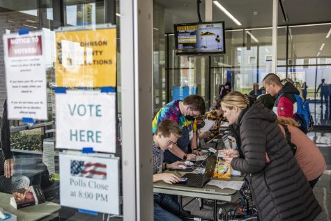 Voters get set up to vote on Election Day at the University of Iowa Campus Recreation and Wellness Center in Iowa City on Tuesday, Nov. 8, 2022. 