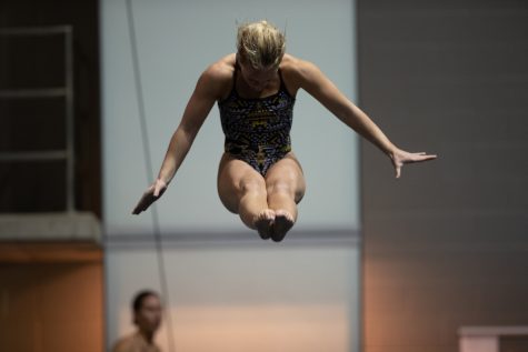 Makayla Hugbanks is seen mid dive during the one meter dive event on day one of the Women’s Swim and Dive at the Campus Recreational and Wellness Center in Iowa City on Thursday, Dec 1, 2022. Hughbanks had a final score of 269.65. 