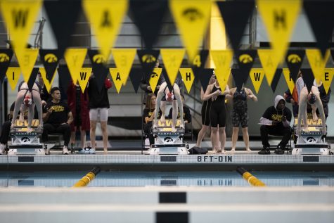 Swimmers prepare to dive into the pool at the start of heat 3 of the 100 meter free stroke during day three of the 2022 Hawkeye Invitational at the Campus Recreation and Wellness Center in Iowa City on Saturday, Dec. 3, 2022. 